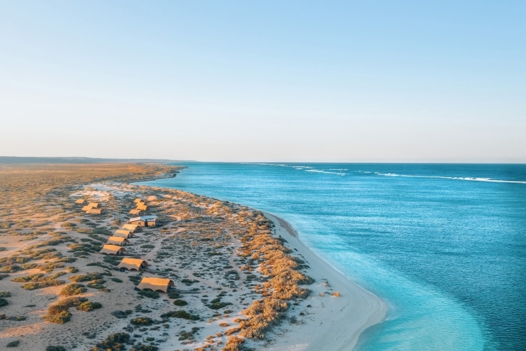 Aerial view of Sal Salis luxury accommodation amid the sand dunes on the coast of the bright blue waters of Ningaloo Reef, Western Australia © Sal Salis Ningaloo Reef Aerial view of Sal Salis luxury accommodation amid the sand dunes on the coast of the bright blue waters of Ningaloo Reef, Western Australia © Sal Salis Ningaloo Reef