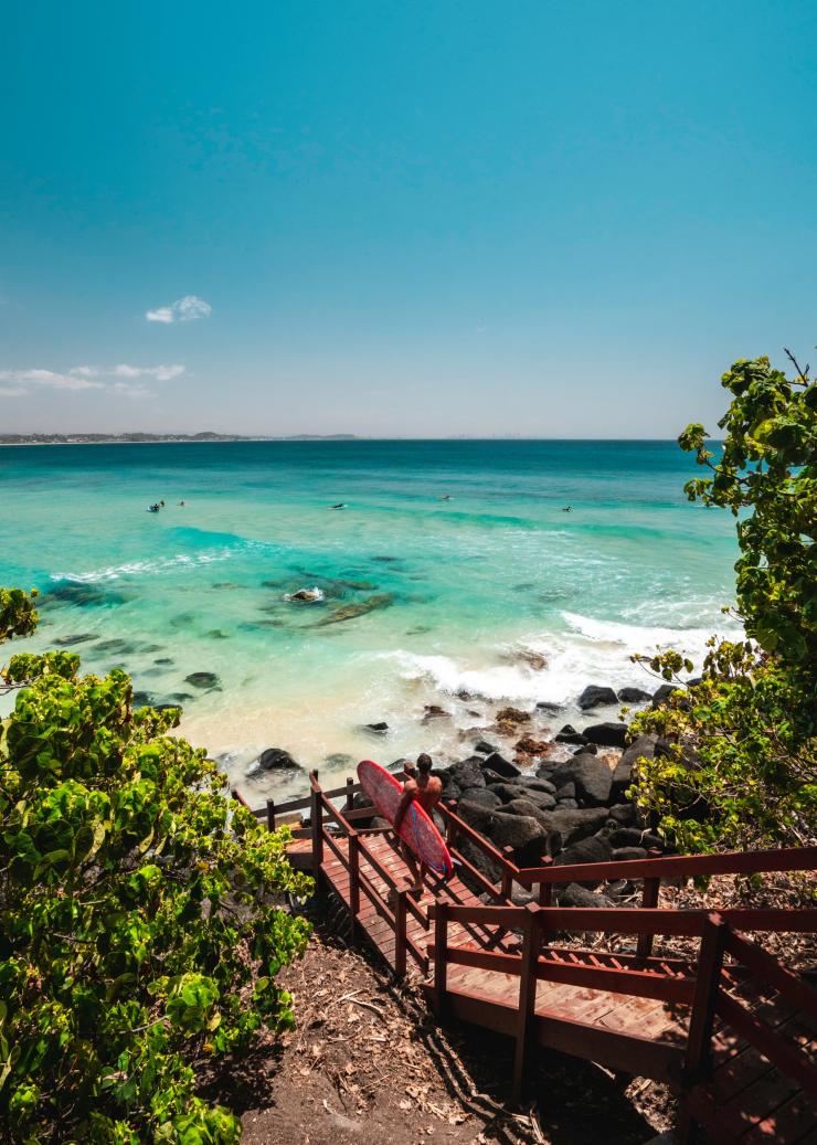 Surfista che cammina verso Rainbow Bay sulla Gold Coast © Tourism and Events Queensland Surfista che cammina verso Rainbow Bay sulla Gold Coast © Tourism and Events Queensland