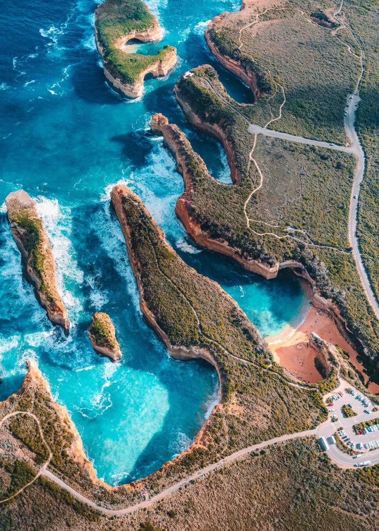 Aerial view of a jagged coastline with limestone stacks standing in the ocean at the  Twelve Apostles, Great Ocean Road, Victoria © Tourism Australia 